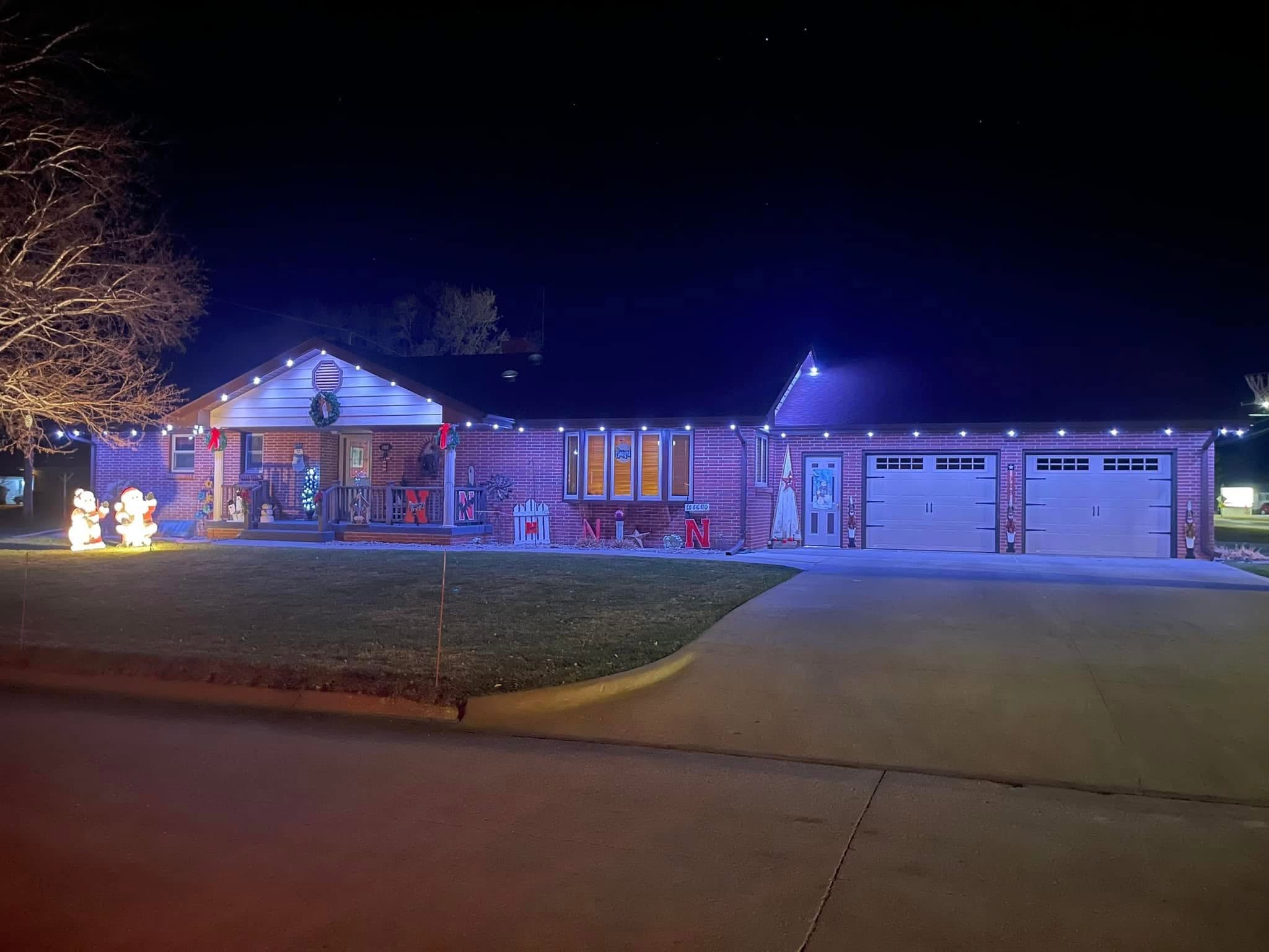 A home illuminated at night, photographed and shared by Root Electric